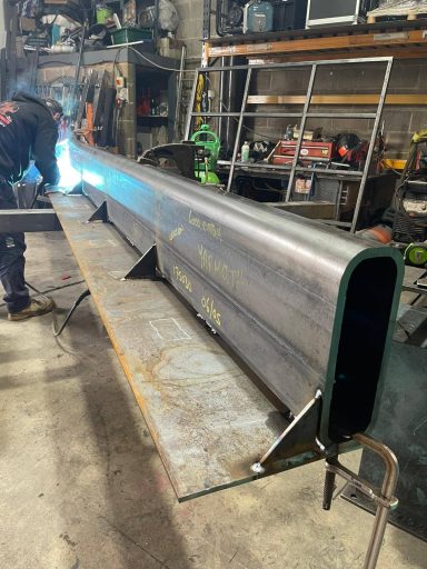 Welding a large curved steel section in the workshop, Rackheath, Norwich