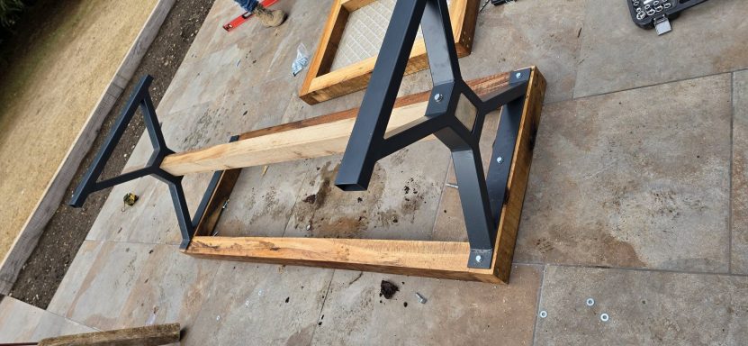 Black steel A-frame table legs on a timber frame, fabricated in Norwich