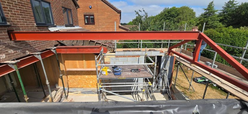 Red oxide primed steel beams and roof frame installed for a house extension, Norfolk
