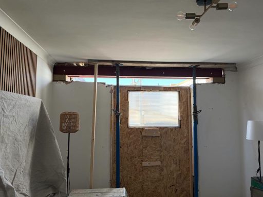 Steel beams on Acrow props over a new opening inside a house, Norfolk